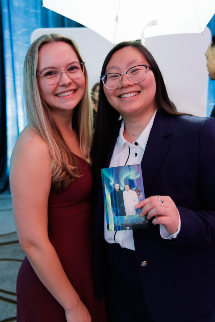 two female guests showing off their ai generated photo booth picture