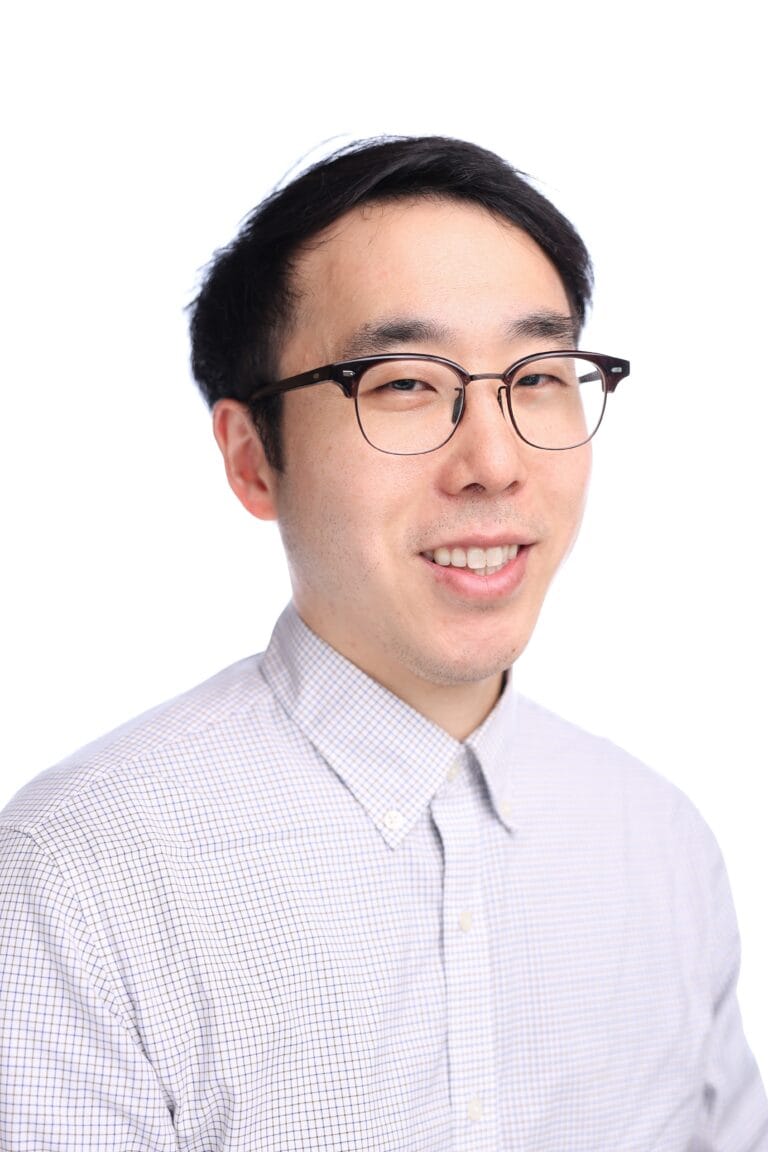 Professional business headshot portrait with glasses against a clean white background