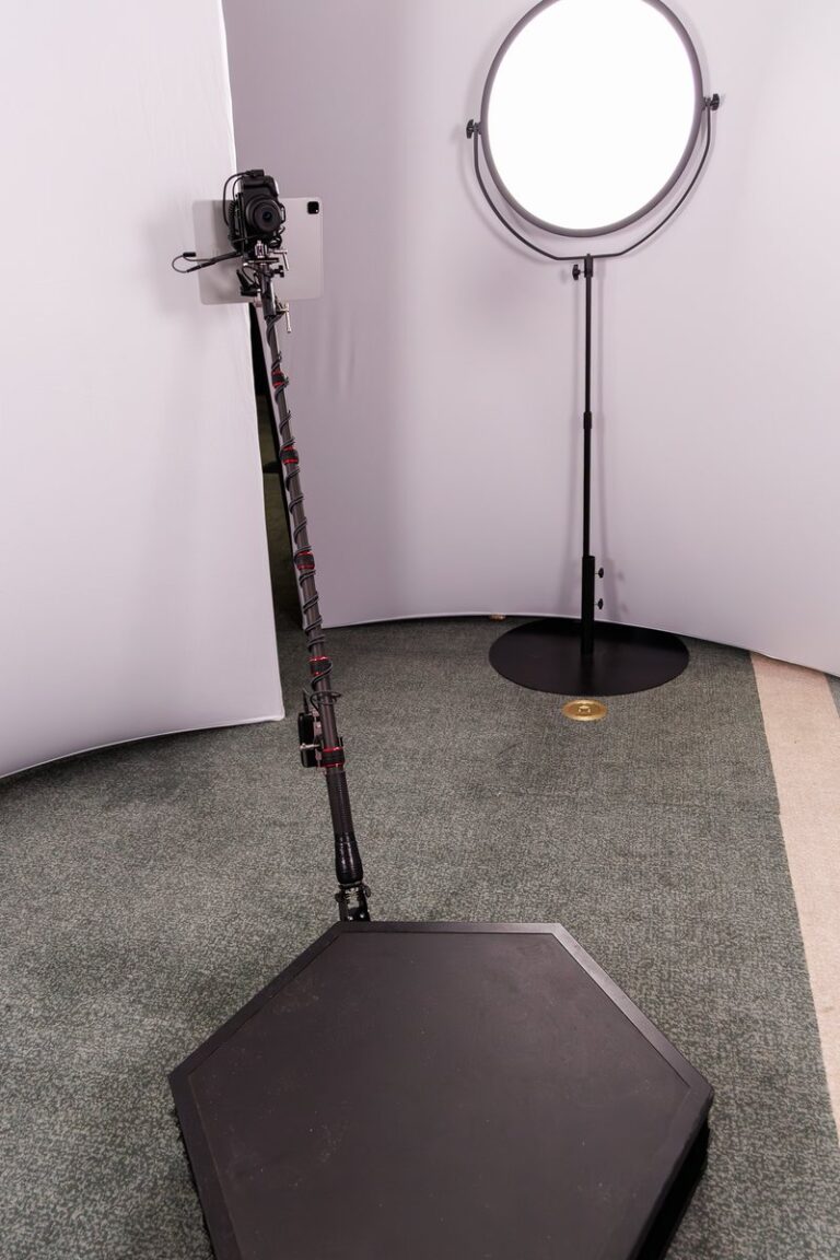 Chicago Photo Booth Rental 2 Empty 360 platform with a camera arm and circular lights against a white backdrop.