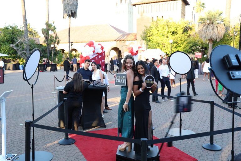 Portland Photo Booth Rental 2 Guests pose on an outdoor 360 platform with circular lights around the set.