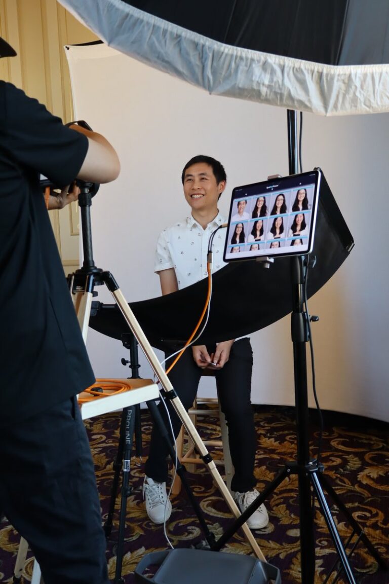 Miami Photo Booth Rental 3 Photographer photographs a guest in a white shirt beside a portrait preview screen.