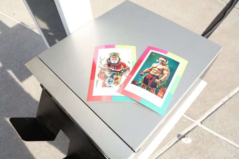 Two colorful illustrated portrait prints displayed on a table.