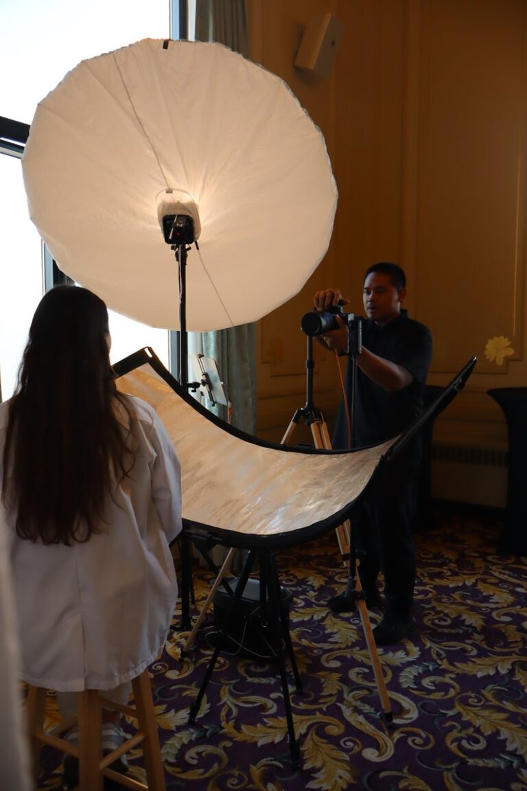 Chicago Photo Booth Rental 3 Portrait session viewed from behind the seated guest, with an umbrella light and reflector.